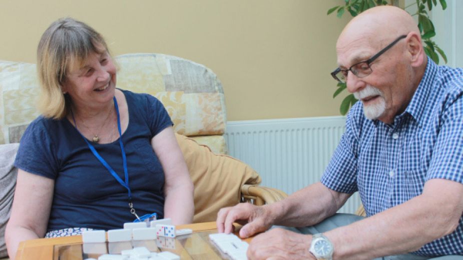 Volunteer spending time with a cared-for person while the carer takes a break