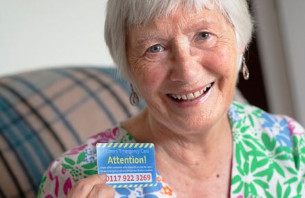 A carer shows her Carers Emergency Card to the camera