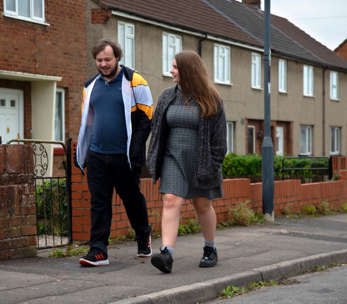 Hollie and Finn walk down a Bristol street chatting with each other